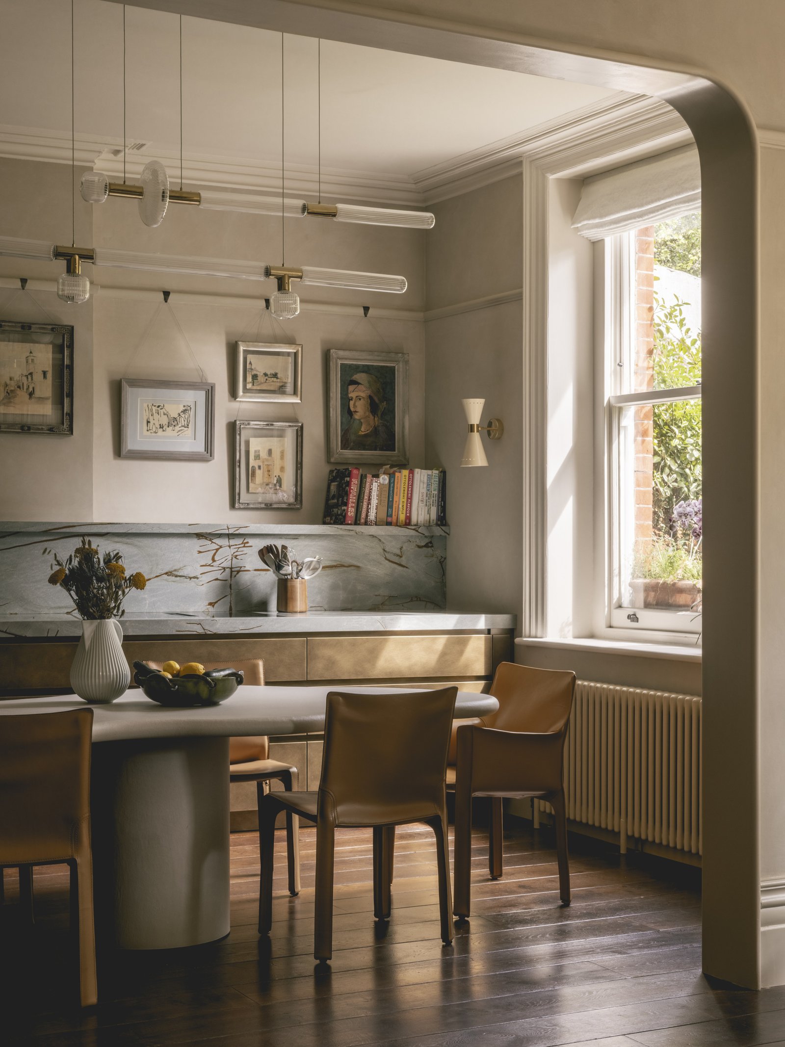 mwai a home reimagined kitchen. metal faced bespoke kitchen, stone table.