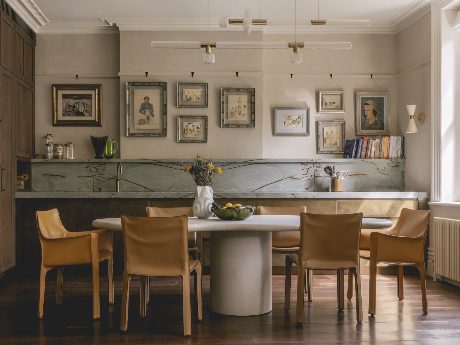 mwai a home reimagined kitchen. metal faced bespoke kitchen, stone table.